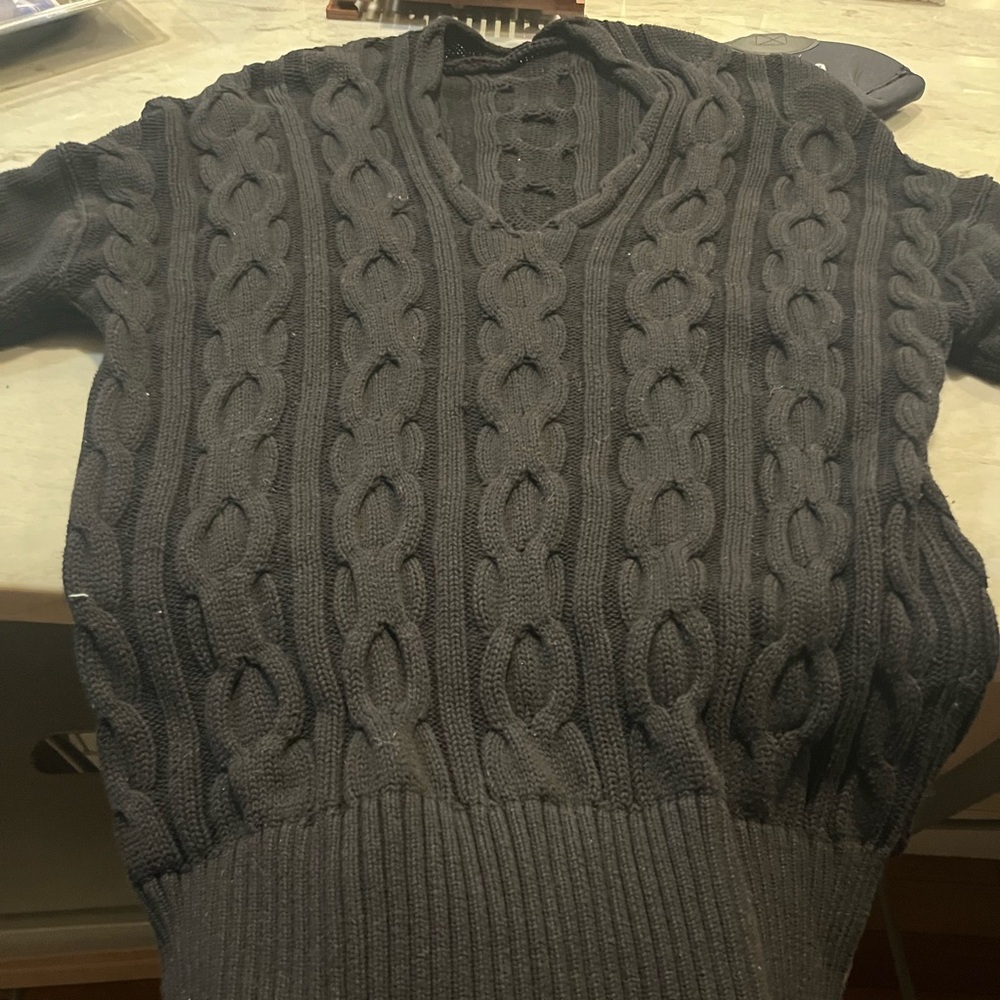 Cable knit v neck sweater.